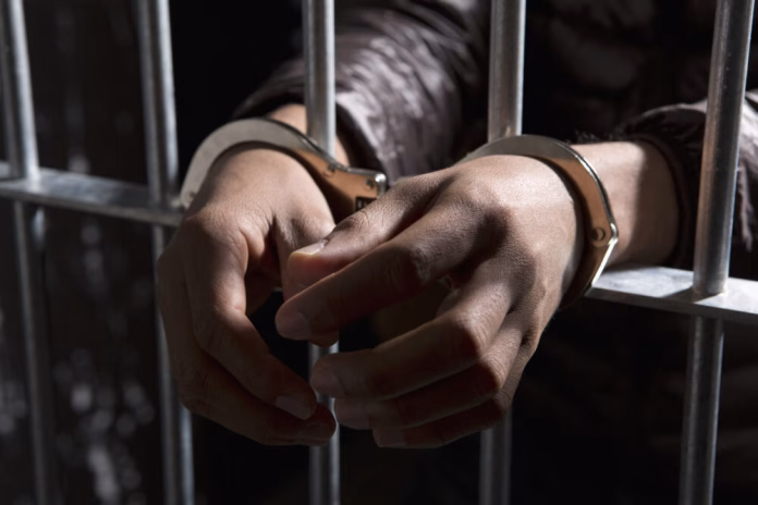 prisoner-behind-bars-handcuffs-jail-prison-getty-e1673729426865-1